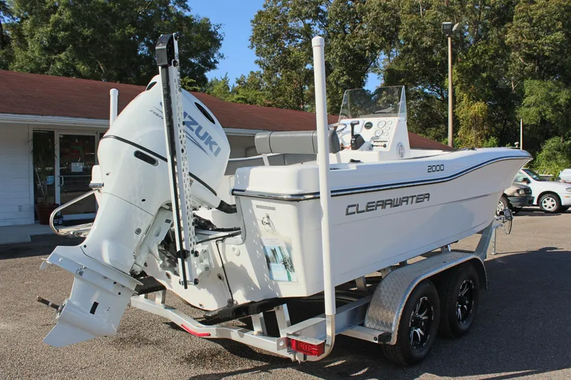 Slide: The Image of 2024 Clear Water 2000 CC boat on trailer with Suzuki outboard motor. - 6