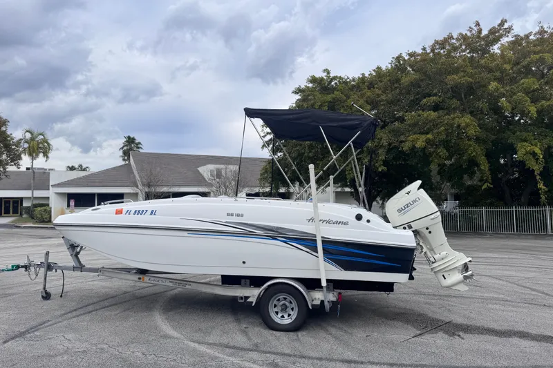 The Image of 2018 Hurricane SunDeck Sport 188 OB boat on trailer, parked outdoors. - 0