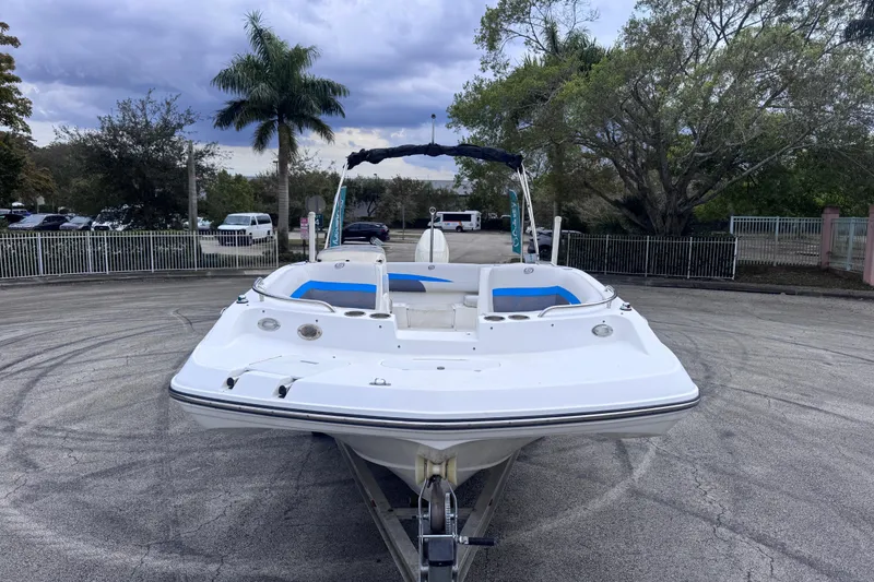 Slide: The Image of 2018 Hurricane SunDeck Sport 188 OB boat on trailer, parked outdoors. - 1