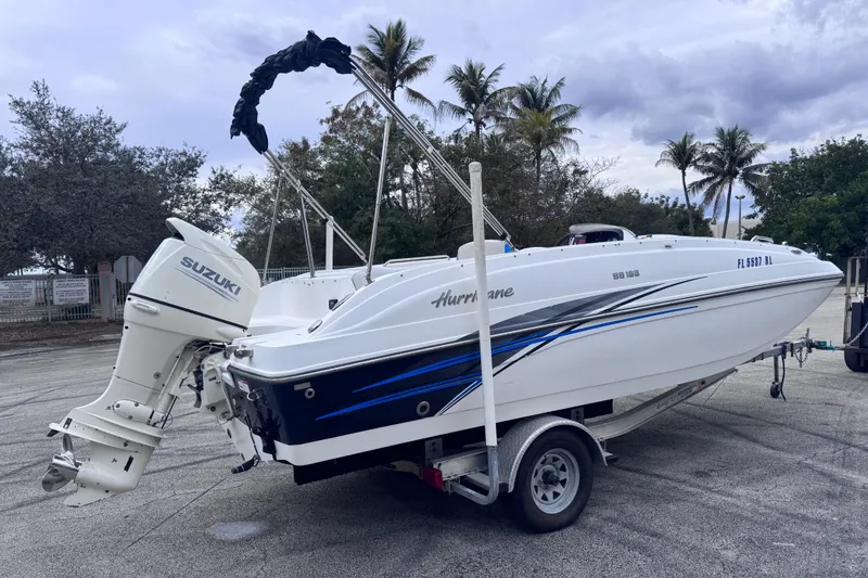 Slide: The Image of 2018 Hurricane SunDeck Sport 188 OB boat with Suzuki outboard motor on trailer. - 4
