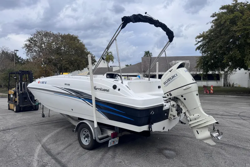 Slide: The Image of 2018 Hurricane SunDeck Sport 188 OB boat with Suzuki outboard motor on trailer. - 6