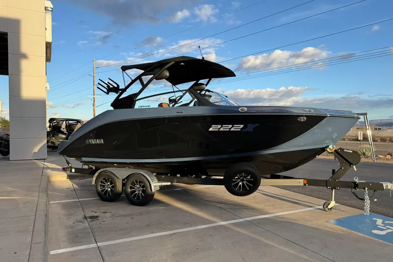 Slide: The Image of 2026 Yamaha Boats 222XD model, close-up of sleek black exterior with logo. - 11