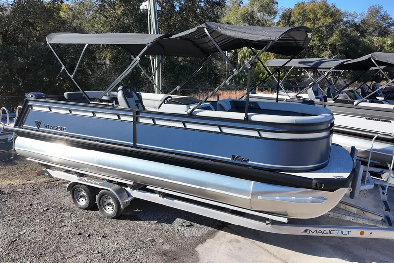 The Image of 2026 Viaggio Lago V 22 C pontoon boat on trailer, featuring sleek design and canopy. - 0