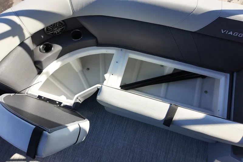 Slide: The Image of 2026 Viaggio Lago V 22 C boat interior with open storage compartment and cup holders. - 12