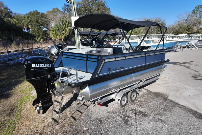 Slide: The Image of 2026 Viaggio Lago V 22 C pontoon boat with Suzuki engine on trailer. - 2