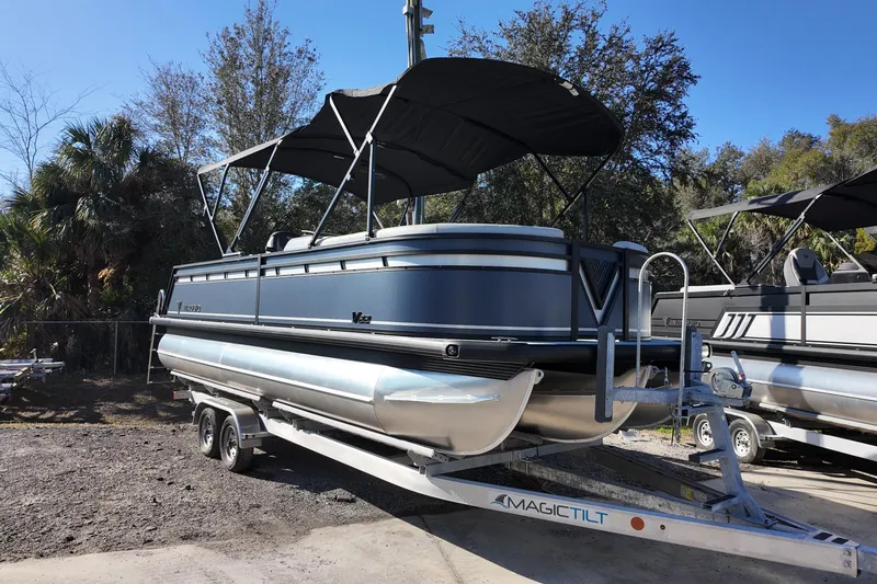 Slide: The Image of 2026 Viaggio Lago V 22 C pontoon boat on trailer, parked outdoors. - 3