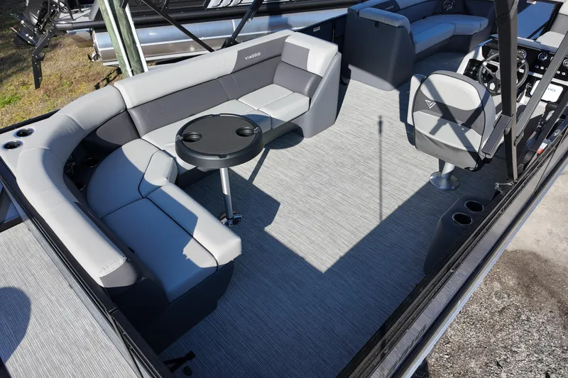 Slide: The Image of 2026 Viaggio Lago V 22 C pontoon boat interior with gray seating and table. - 5