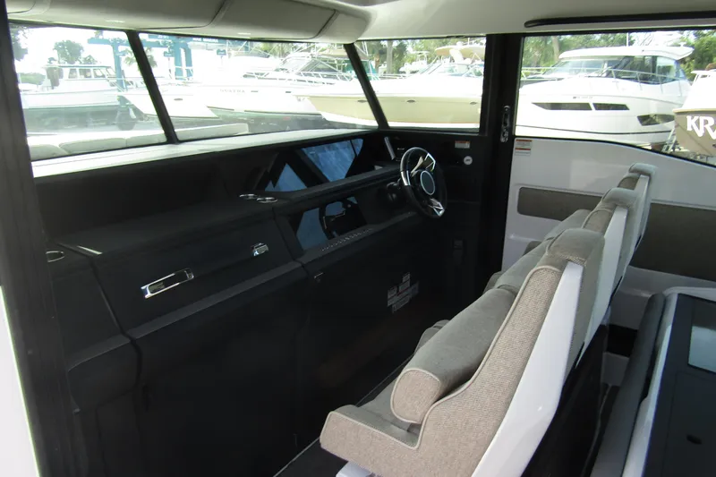 Slide: The Image of 2024 Axopar 45 XC Cross Cabin BRABUS Trim interior with modern steering and seating. - 15