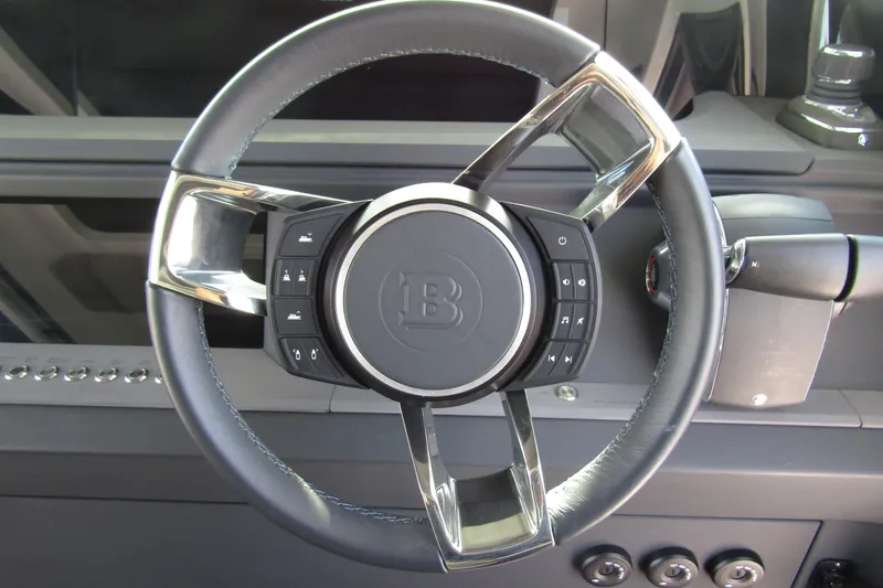 Slide: The Image of Steering wheel of 2024 Axopar 45 XC Cross Cabin BRABUS Trim with control buttons. - 18