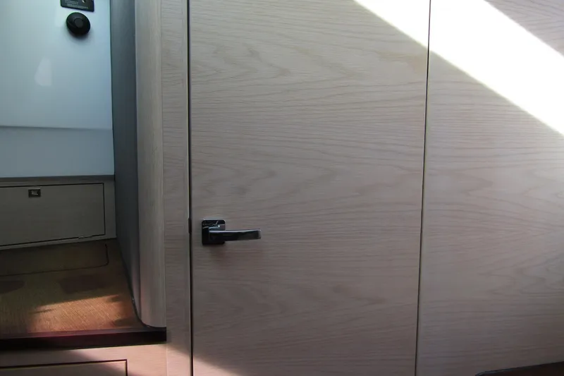 Slide: The Image of Interior view of 2024 Axopar 45 XC Cross Cabin BRABUS Trim, featuring sleek wooden paneling. - 24