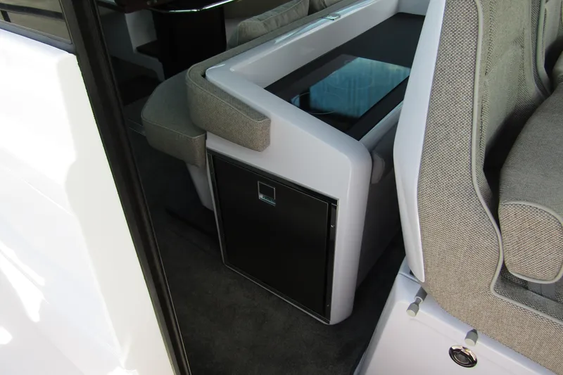 Slide: The Image of 2024 Axopar 45 XC Cross Cabin BRABUS Trim interior seating and storage detail. - 32