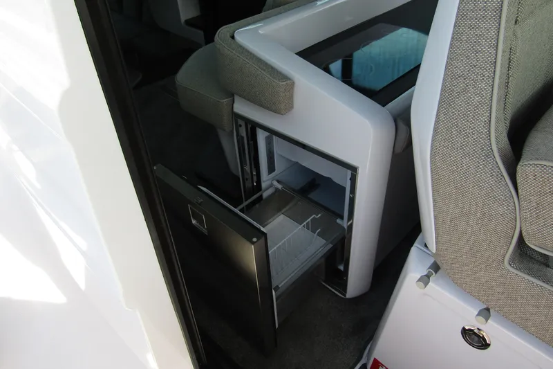 Slide: The Image of 2024 Axopar 45 XC Cross Cabin BRABUS Trim interior with open storage compartment. - 33