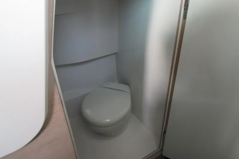 Slide: The Image of 2024 Axopar 45 XC Cross Cabin BRABUS Trim bathroom interior with modern toilet design. - 40