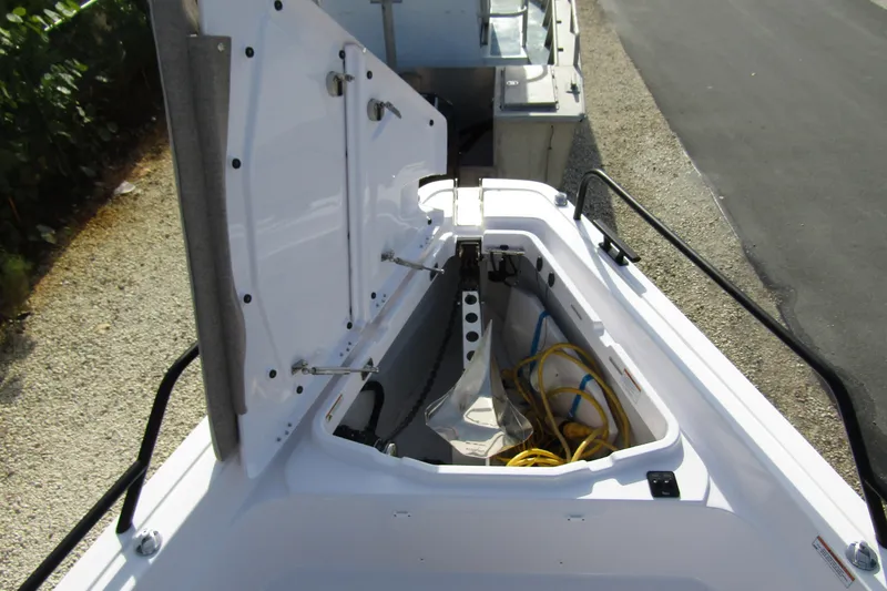 Slide: The Image of 2024 Axopar 45 XC Cross Cabin BRABUS Trim storage compartment with open hatch. - 5