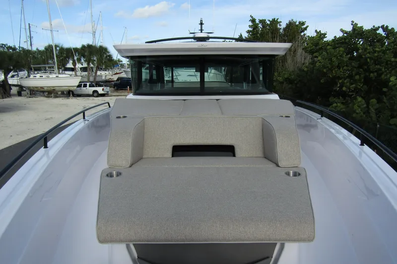 Slide: The Image of 2024 Axopar 45 XC Cross Cabin BRABUS Trim with sleek deck seating and modern design. - 6