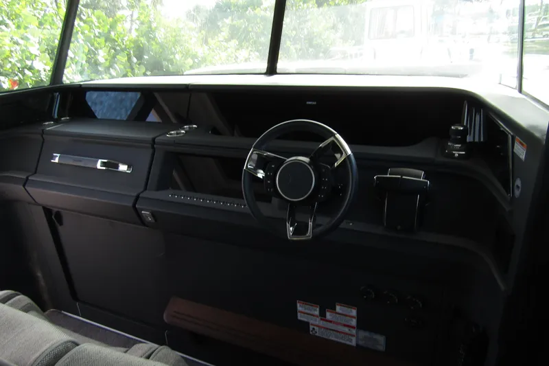 Slide: The Image of 2024 Axopar 45 XC Cross Cabin BRABUS Trim interior dashboard with steering wheel. - 16