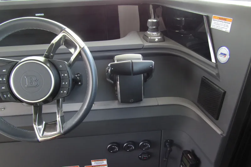 Slide: The Image of 2024 Axopar 45 XC Cross Cabin BRABUS Trim dashboard with steering wheel and controls. - 19