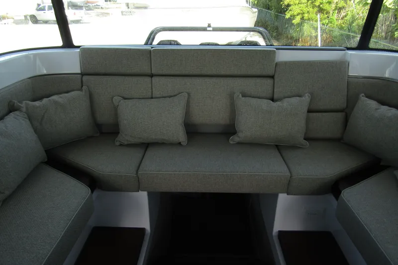 Slide: The Image of 2024 Axopar 45 XC Cross Cabin BRABUS Trim interior seating with gray cushions. - 28