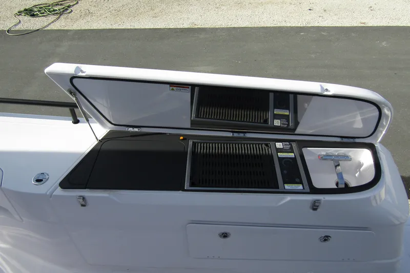 Slide: The Image of 2024 Axopar 45 XC Cross Cabin BRABUS Trim with open storage compartment. - 47