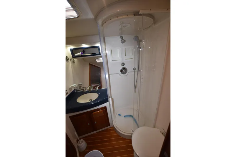 Slide: The Image of Bathroom interior of 1998 Cabo 45 Express yacht with shower and sink. - 13
