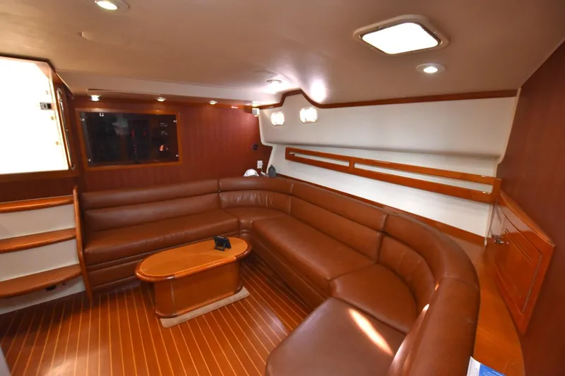 Slide: The Image of Luxurious interior of 1998 Cabo 45 Express yacht with leather seating and wooden accents. - 14