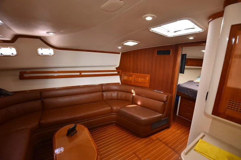 Slide: The Image of Luxurious interior of a 1998 Cabo 45 Express yacht with leather seating and wood accents. - 17