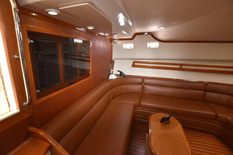Slide: The Image of Luxurious interior of a 1998 Cabo 45 Express yacht with leather seating and wood accents. - 18