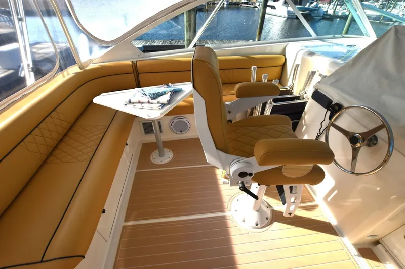 Slide: The Image of Luxurious interior of 1998 Cabo 45 Express yacht with tan seating and steering wheel. - 6