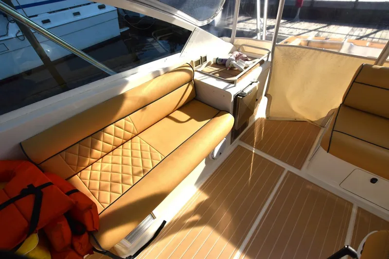 Slide: The Image of Interior of 1998 Cabo 45 Express boat with tan seating and wood flooring. - 7