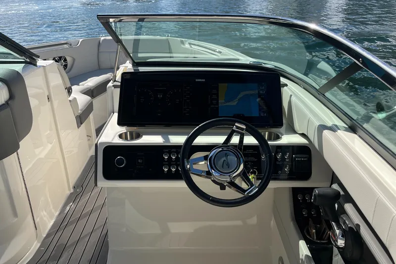 Slide: The Image of 2021 Sea Ray SLX 280 boat dashboard with steering wheel and navigation display. - 16