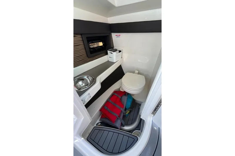 Slide: The Image of Interior of 2021 Sea Ray SLX 280 boat bathroom with sink and toilet. - 21