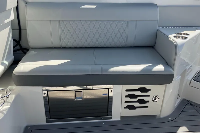 Slide: The Image of 2021 Sea Ray SLX 280 boat seat with storage and cup holders. - 29