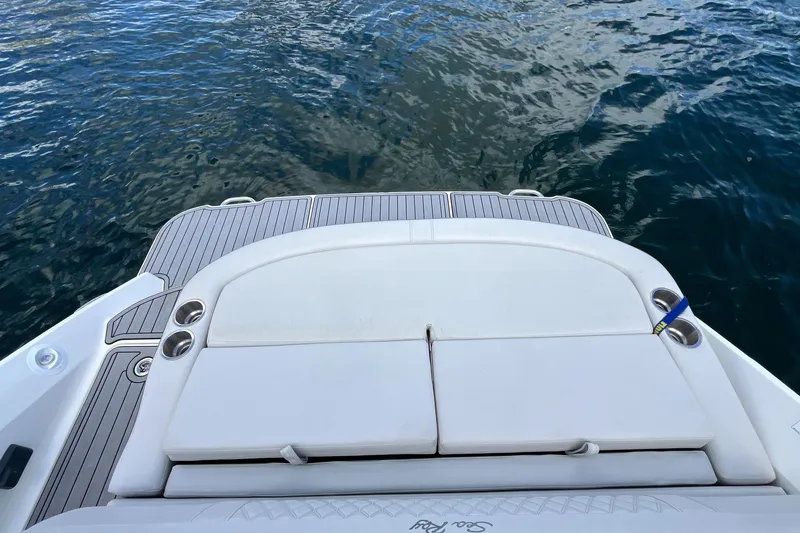 Slide: The Image of 2021 Sea Ray SLX 280 boat swim platform with cup holders, overlooking calm water. - 37