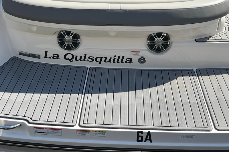 Slide: The Image of 2021 Sea Ray SLX 280 boat deck with "La Quisquilla" name and speakers. - 38