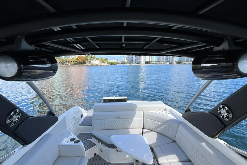 Slide: The Image of 2021 Sea Ray SLX 280 boat interior with luxurious seating and scenic waterfront view. - 40