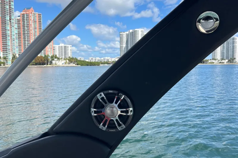 Slide: The Image of Sea Ray SLX 280 boat interior with speaker, city skyline, and water view. - 42