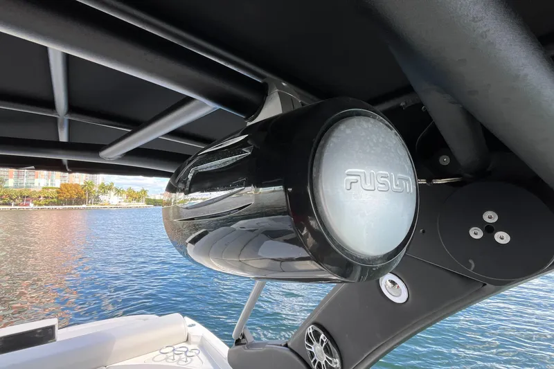 Slide: The Image of Speaker system on 2021 Sea Ray SLX 280 boat, overlooking a scenic waterfront. - 44