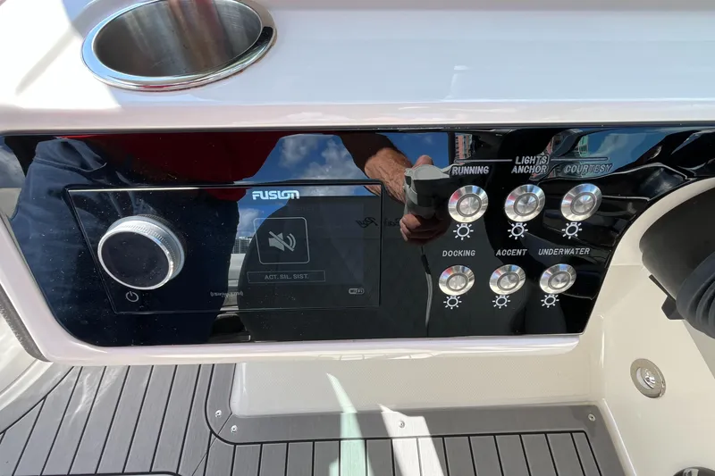 Slide: The Image of Control panel of 2021 Sea Ray SLX 280 boat with various light switches. - 48