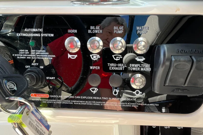 Slide: The Image of Control panel of a 2021 Sea Ray SLX 280 boat with various switches and warnings. - 49