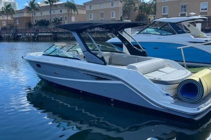 Slide: The Image of 2021 Sea Ray SLX 280 boat docked in a marina with calm water. - 5