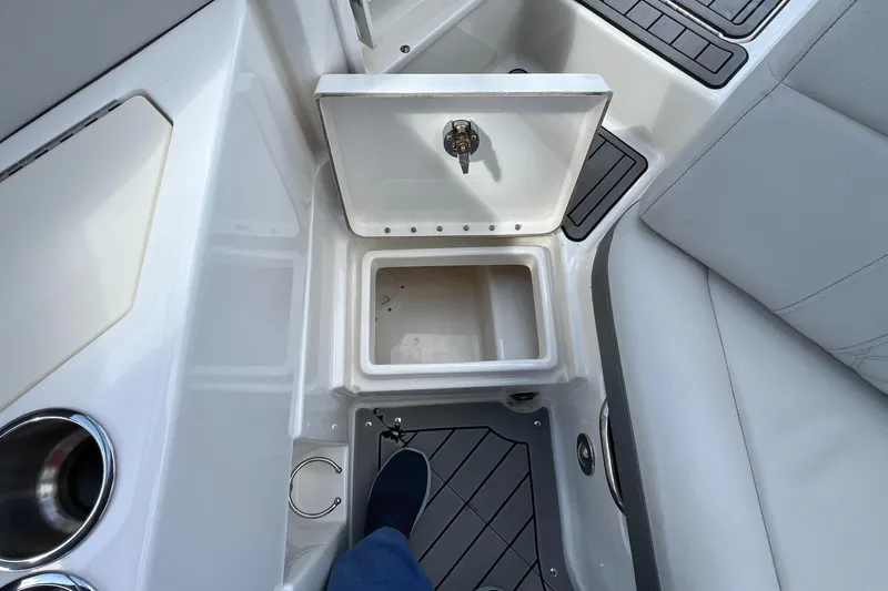 Slide: The Image of 2021 Sea Ray SLX 280 boat interior with open storage compartment and seating. - 54