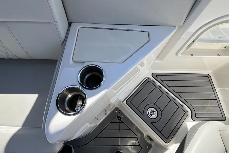 Slide: The Image of 2021 Sea Ray SLX 280 interior with cup holders and storage compartments. - 66