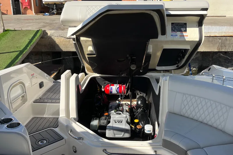 Slide: The Image of 2021 Sea Ray SLX 280 boat engine compartment with open hatch, showcasing V8 engine. - 70