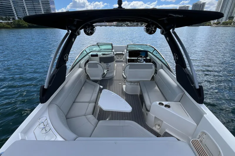 Slide: The Image of 2021 Sea Ray SLX 280 boat interior with spacious seating and modern helm on the water. - 8