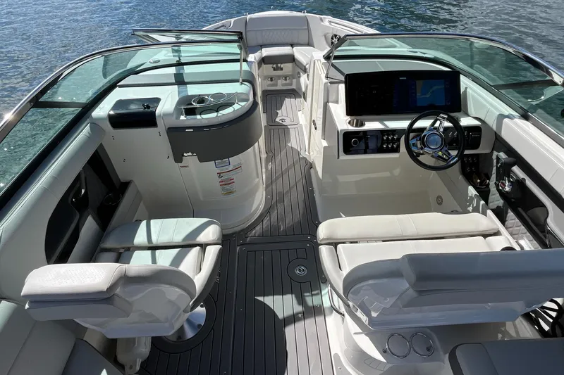 Slide: The Image of 2021 Sea Ray SLX 280 boat interior with modern helm and seating on water. - 9