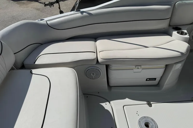 Slide: The Image of 2004 Crownline 248 BR boat interior with cushioned seating and built-in cooler. - 11