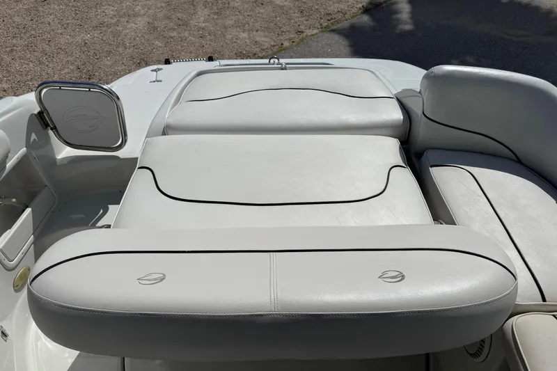 Slide: The Image of 2004 Crownline 248 BR boat with white cushioned seating and sleek design. - 12