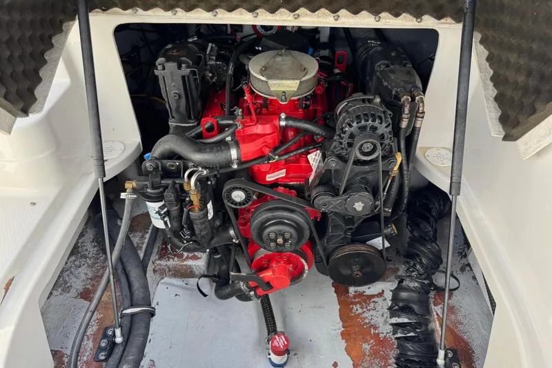 Slide: The Image of Engine compartment of a 2004 Crownline 248 BR boat, featuring a red engine. - 13