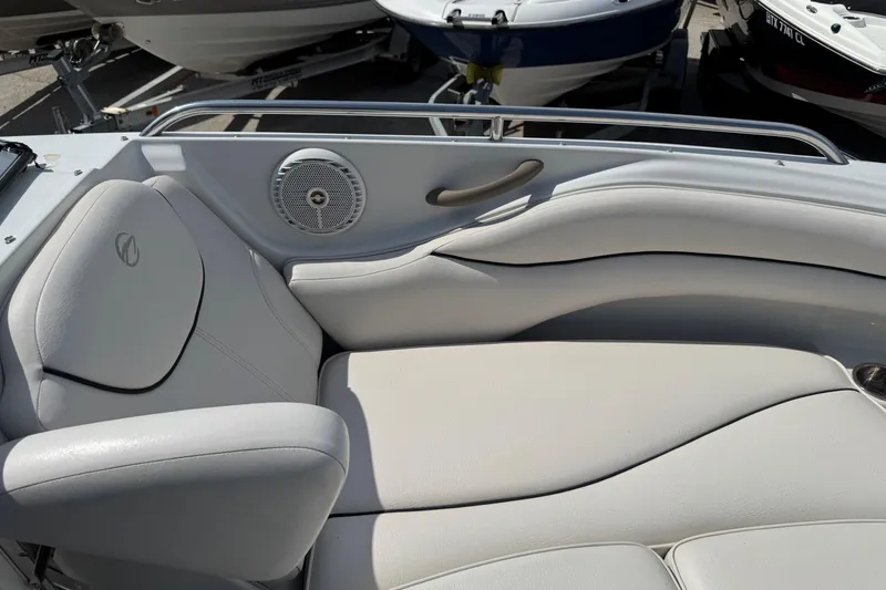 Slide: The Image of 2004 Crownline 248 BR boat interior with white leather seating and speaker. - 16