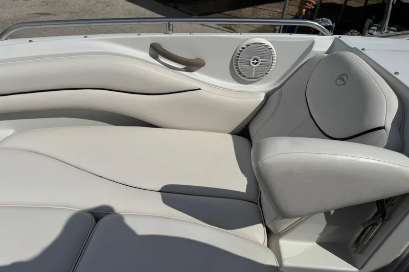 Slide: The Image of 2004 Crownline 248 BR boat interior with white leather seating and speaker. - 17